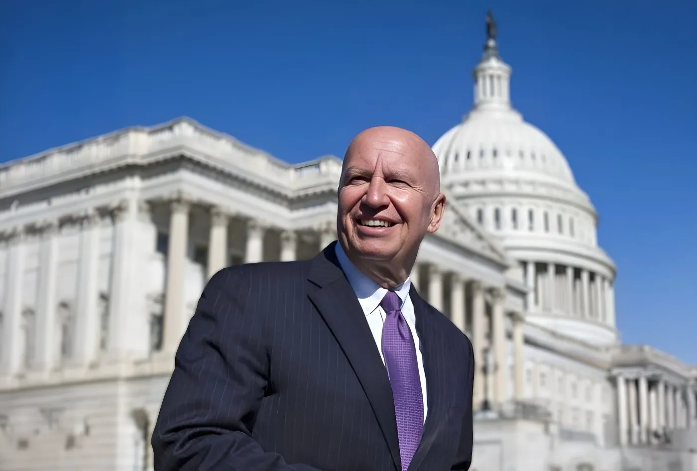 Congressman Brady, in a suit and carrying papers, in front of the U.S. Capitol Building